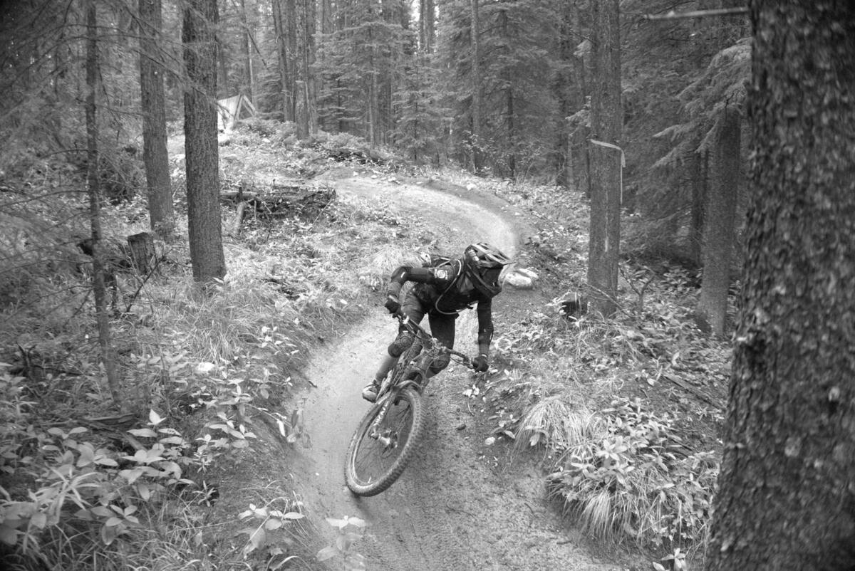 mountain biker leaning through a tight switchback, seen from above